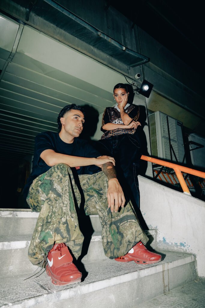 A dramatic portrait of Emad and Elika posing on a staircase.